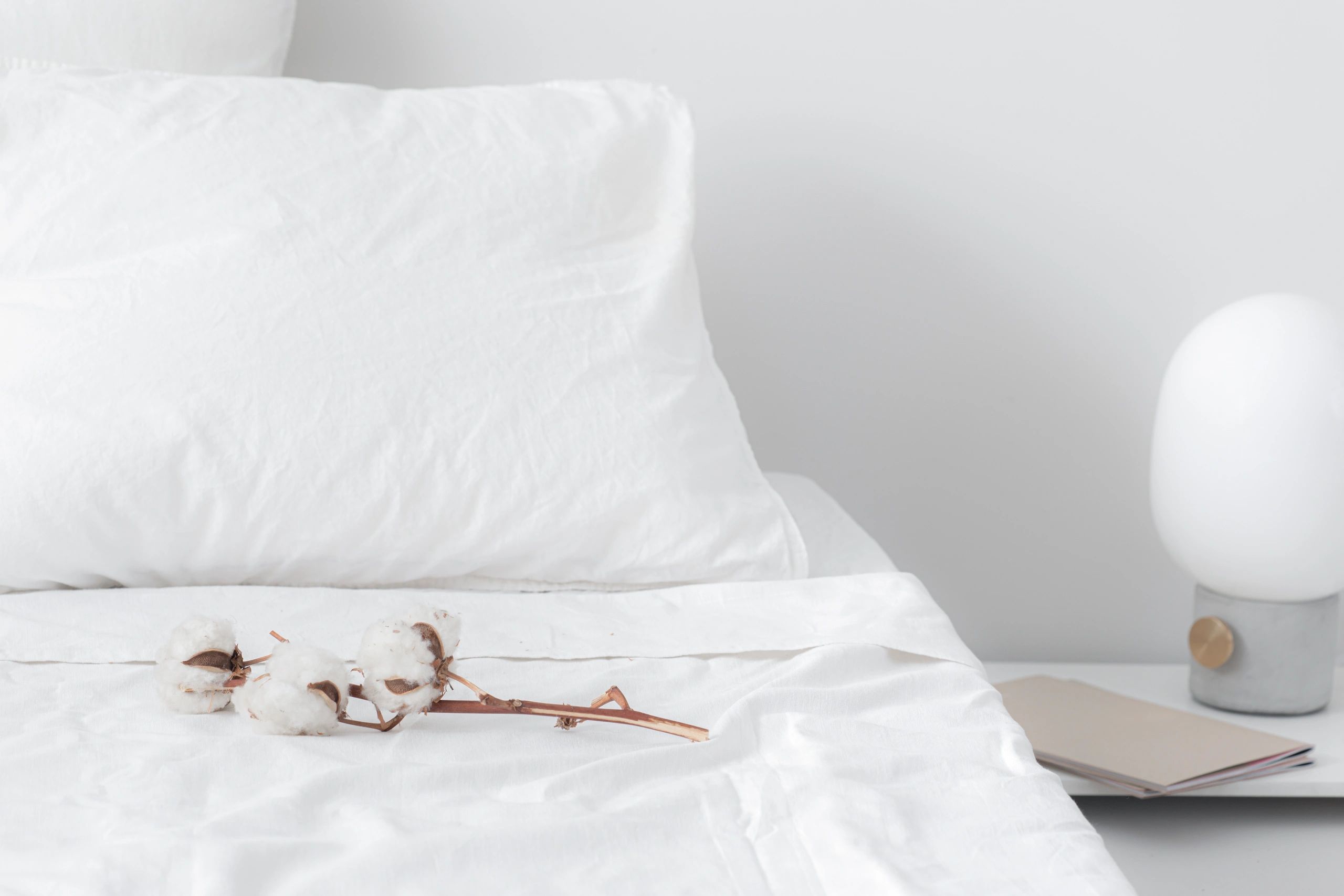 Fresh white hotel linens on a neatly made bed